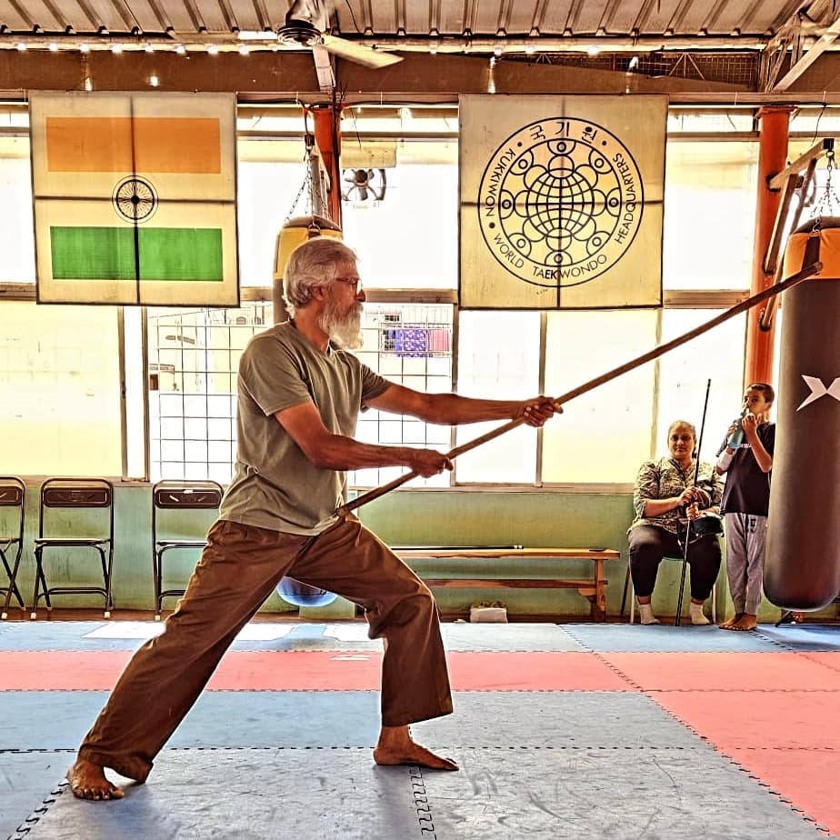 Master KK — Silambam staff in the dojo